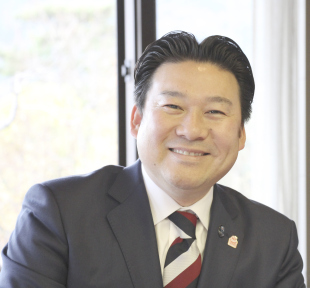 笑顔の長野市長のバストアップ写真